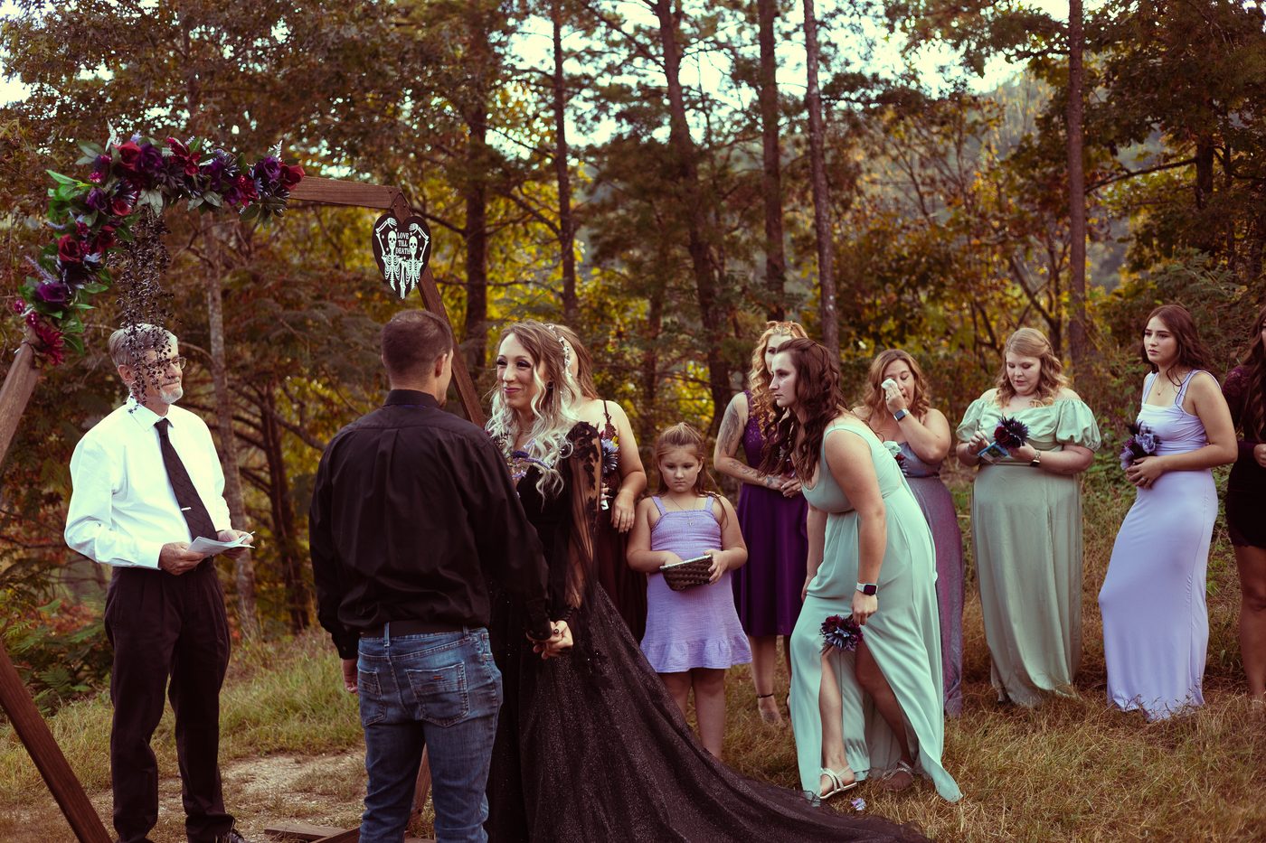 The wedding party and family gathered together outdoors